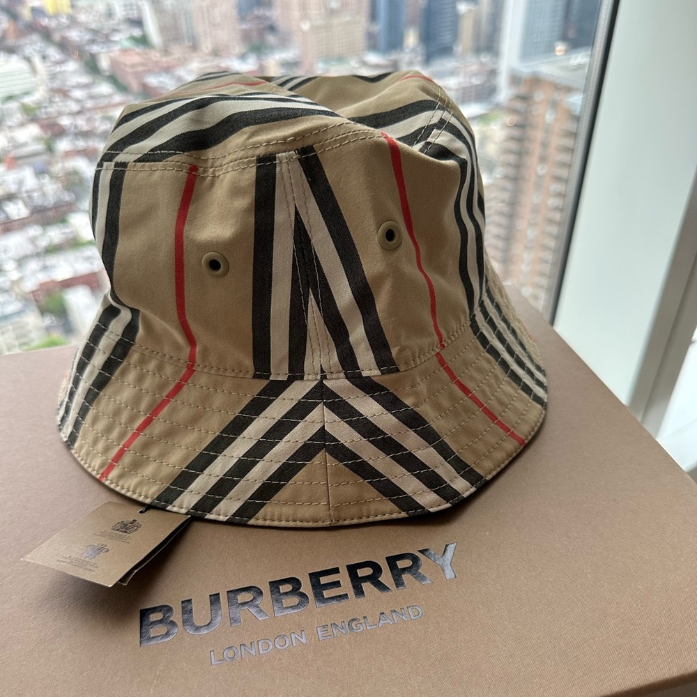 The Burberry Reversible Icon Stripe Cotton Bucket Hat in Archive Stripes + Black